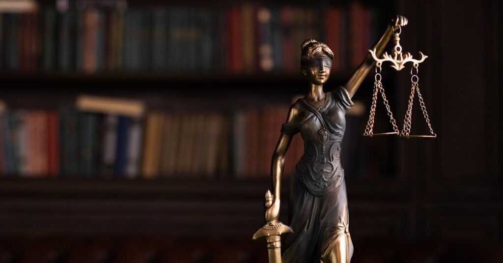 Lady Justice and gavel on a table in a classic law library setting.